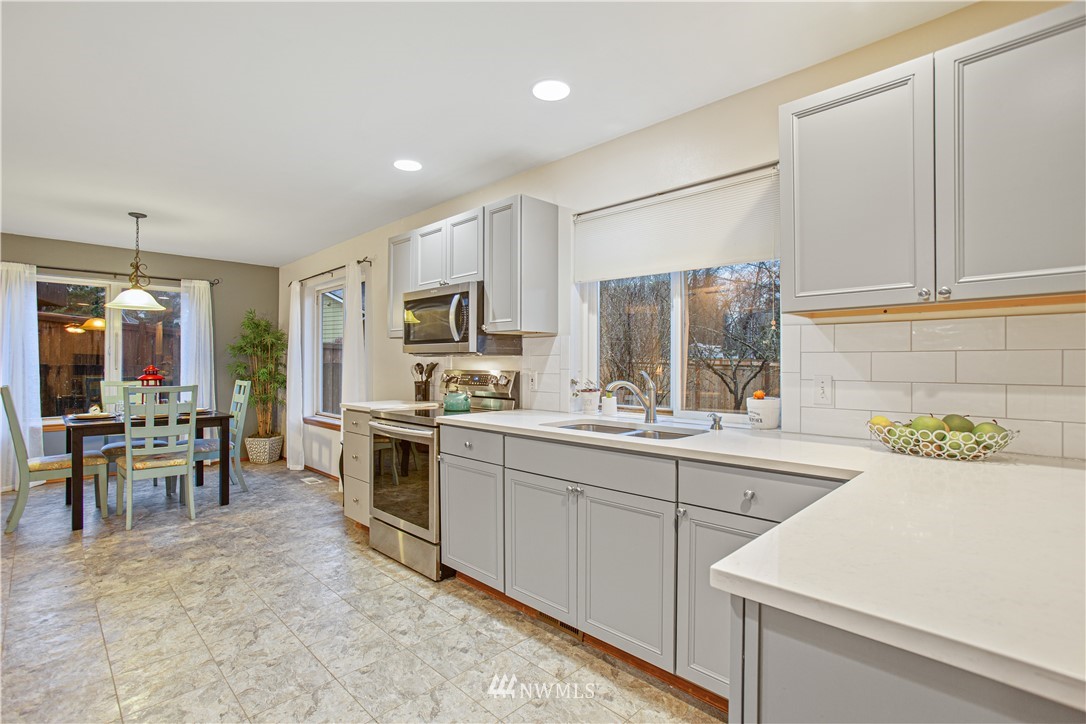 22412 15th Place West Bothell, WA 98021 - Photo 8 of 25 a kitchen with stainless steel appliances kitchen island granite countertop a sink and cabinets
