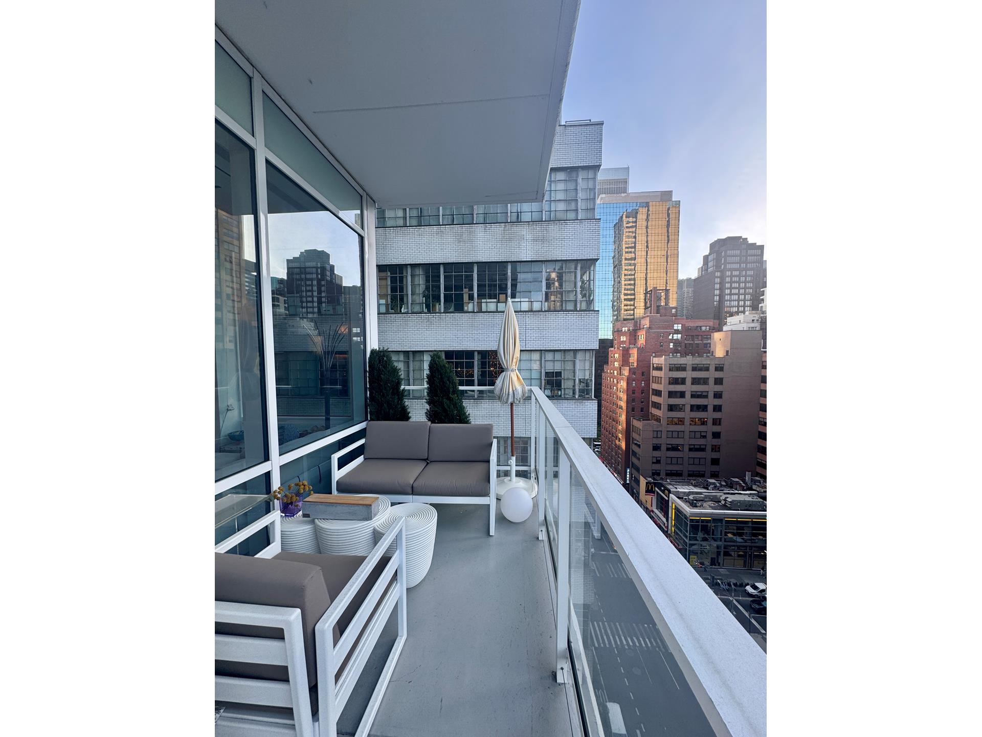200 East 59th Street, Unit 8B Manhattan, NY 10022 - Photo 11 of 21 a kitchen with stainless steel appliances kitchen island granite countertop a stove and a refrigerator