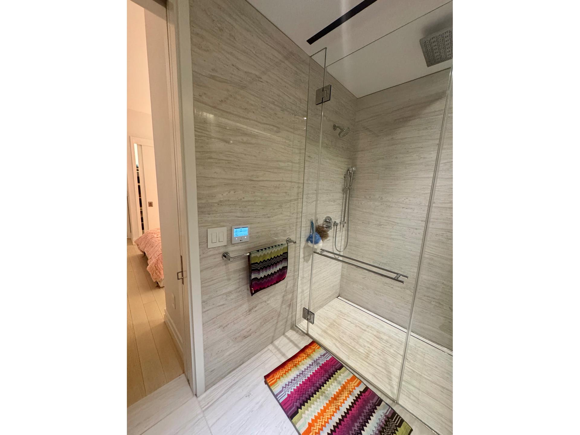 200 East 59th Street, Unit 8B Manhattan, NY 10022 - Photo 8 of 21 a bathroom with a bathtub and a shower