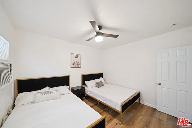 a bedroom with a bed and a ceiling fan