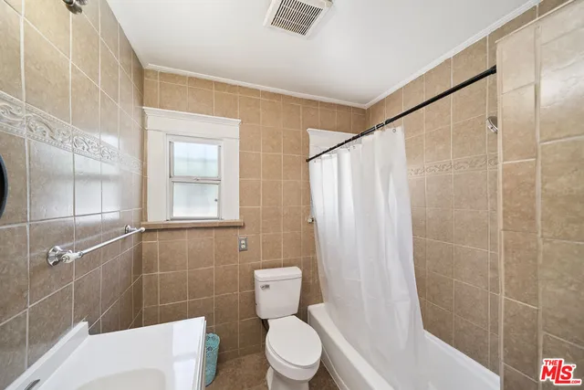 a bathroom with a toilet and shower