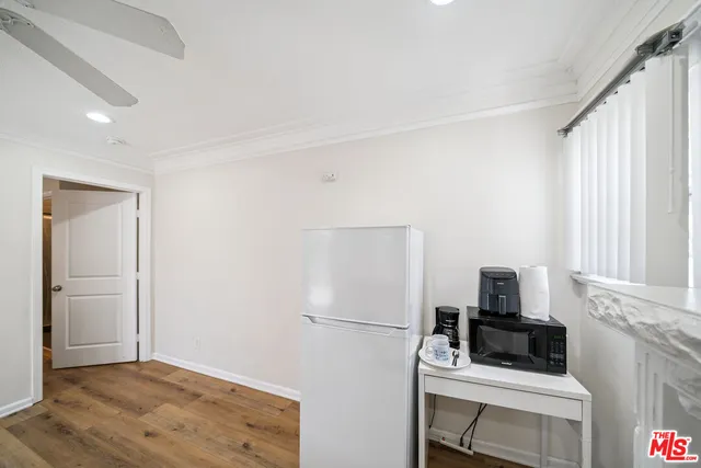 a room with a refrigerator and a window