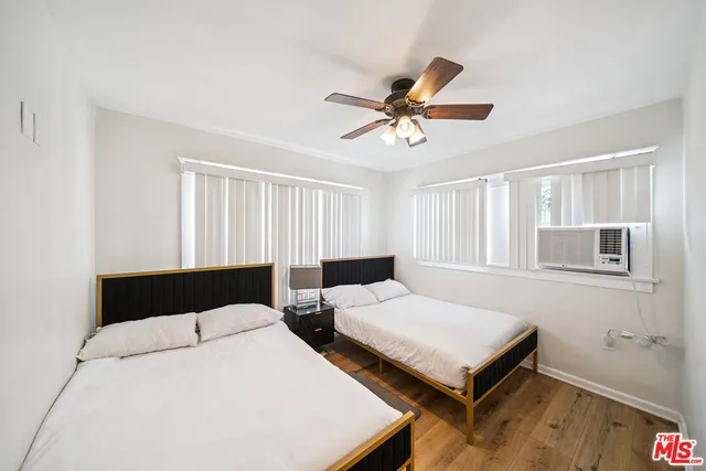 a bedroom with two beds and a window