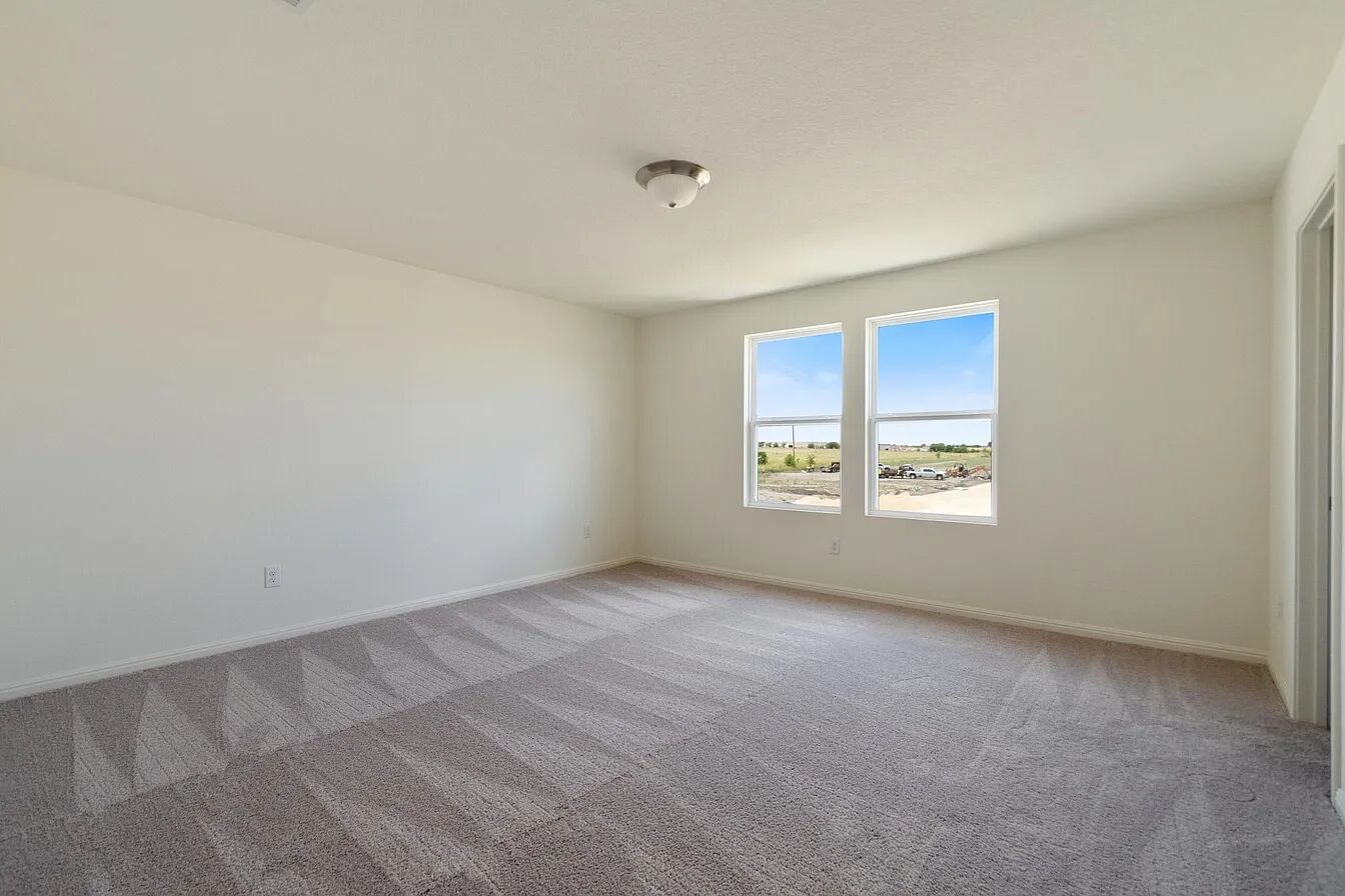 101 Aoudad Road Hutto, TX 78634 - Photo 35 of 39 A quiet secondary bedroom offers serene views and ample space for relaxation.