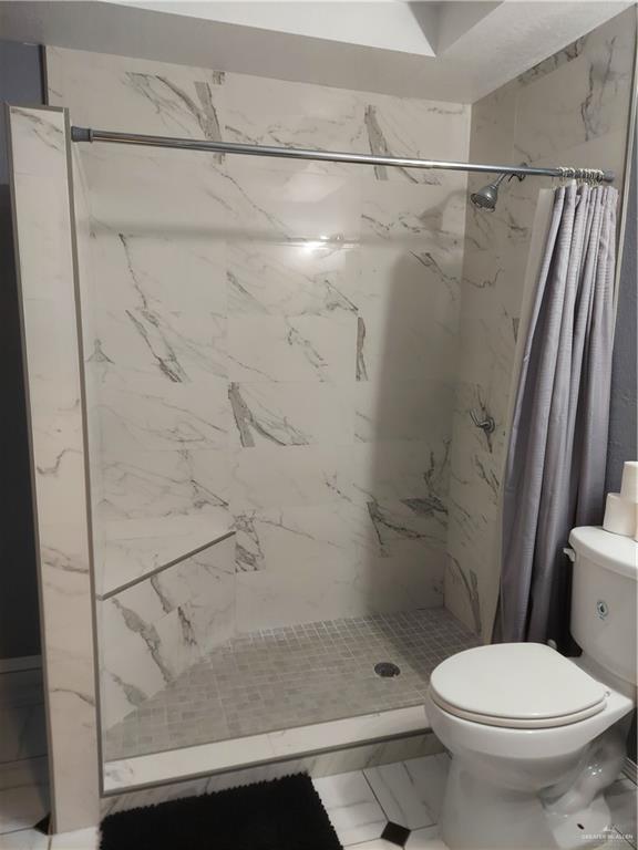 115 Breyfogle Road Palmview, TX 78572 - Photo 13 of 31 a bathroom with a shower and a toilet