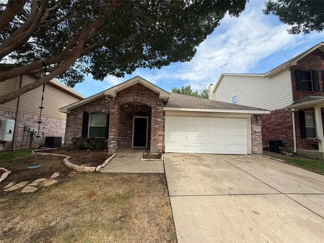 a front view of a house with a garage