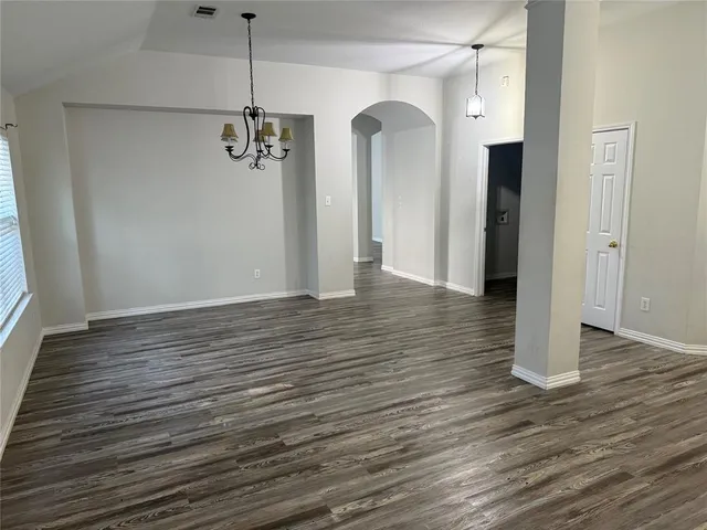 a view of a room with wooden floor