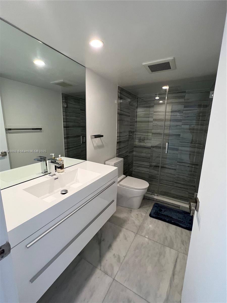 101 Crandon Boulevard, Unit 474 Key Biscayne, FL 33149 - Photo 9 of 9 a bathroom with a sink a toilet and shower