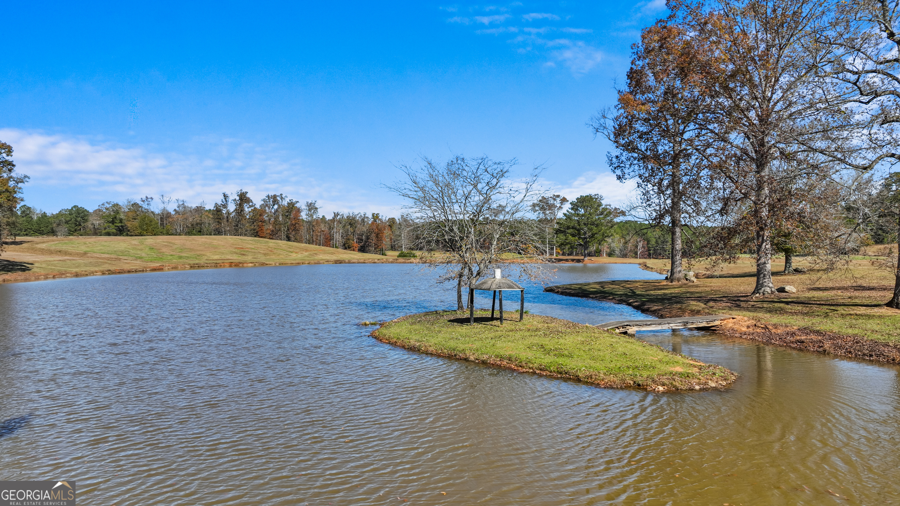 1390 Walker Road Madison, GA 30650 - Photo 23 of 64 a view of a swimming pool with an outdoor space and seating area