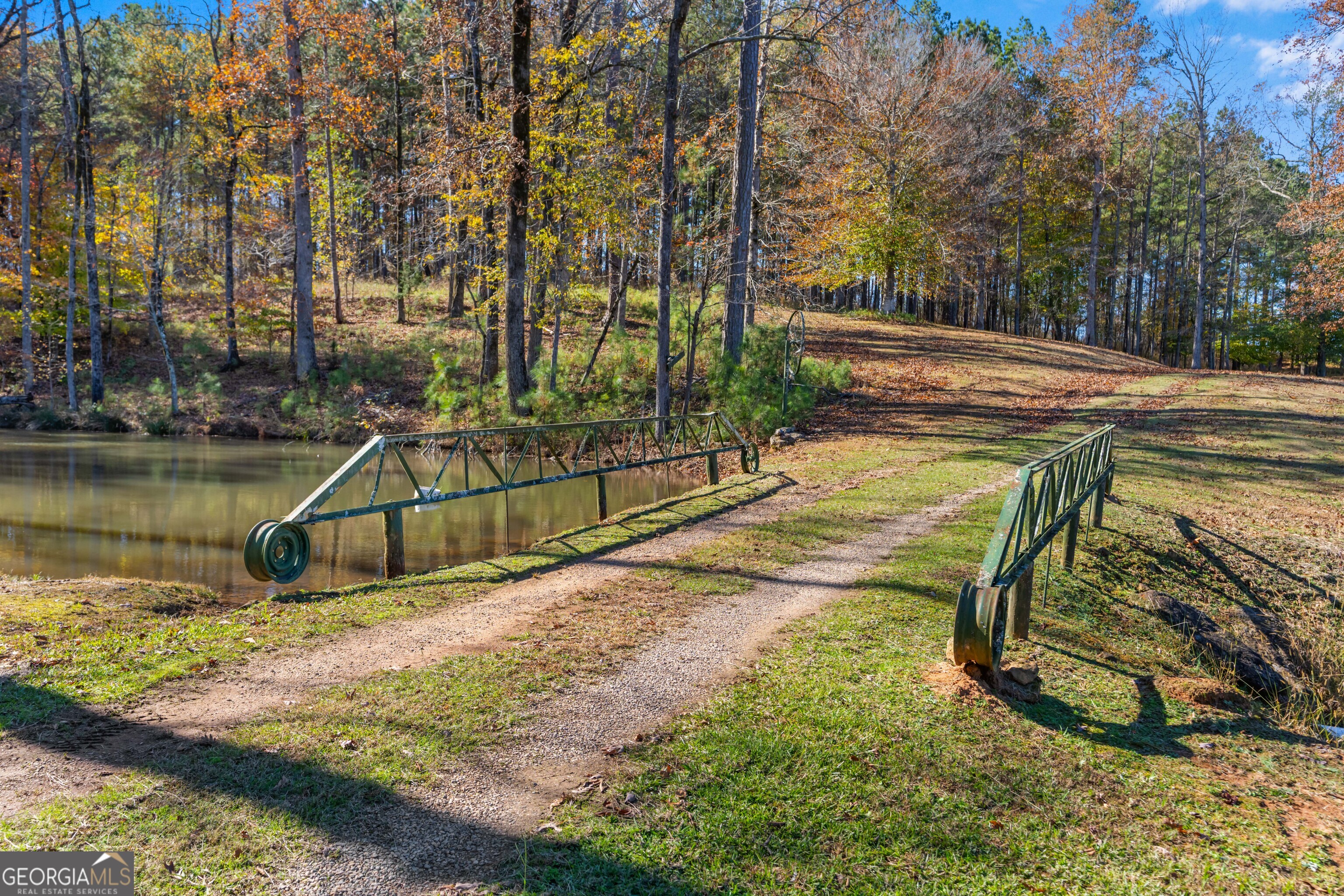 1390 Walker Road Madison, GA 30650 - Photo 26 of 64 a view of a swimming pool with a patio and a yard
