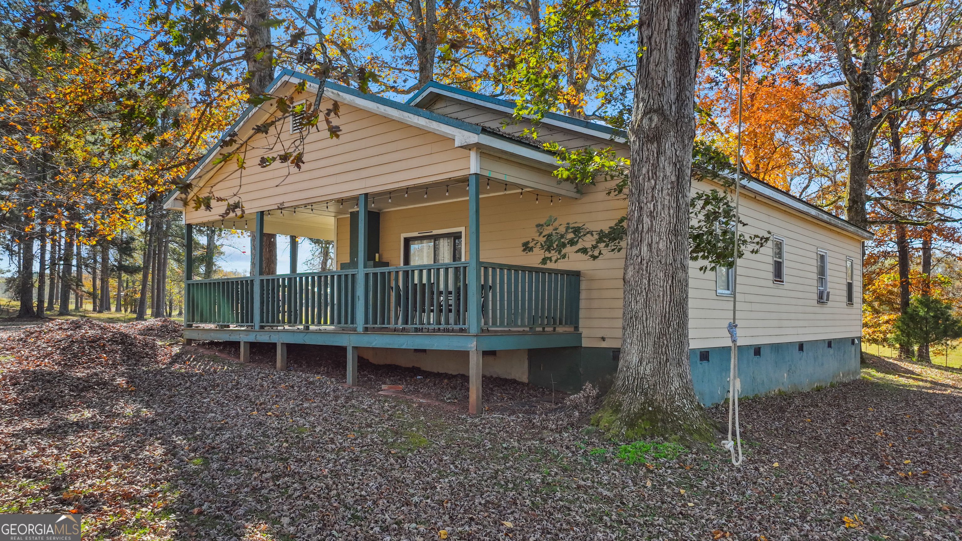 1390 Walker Road Madison, GA 30650 - Photo 60 of 64 a view of a house with a yard and wooden fence