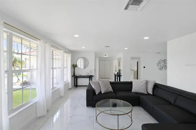a view of a livingroom with workspace and a window