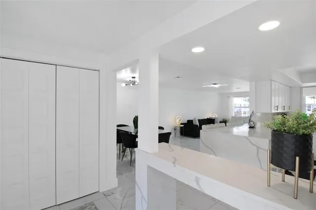 a living room with furniture a chandelier and a dining room