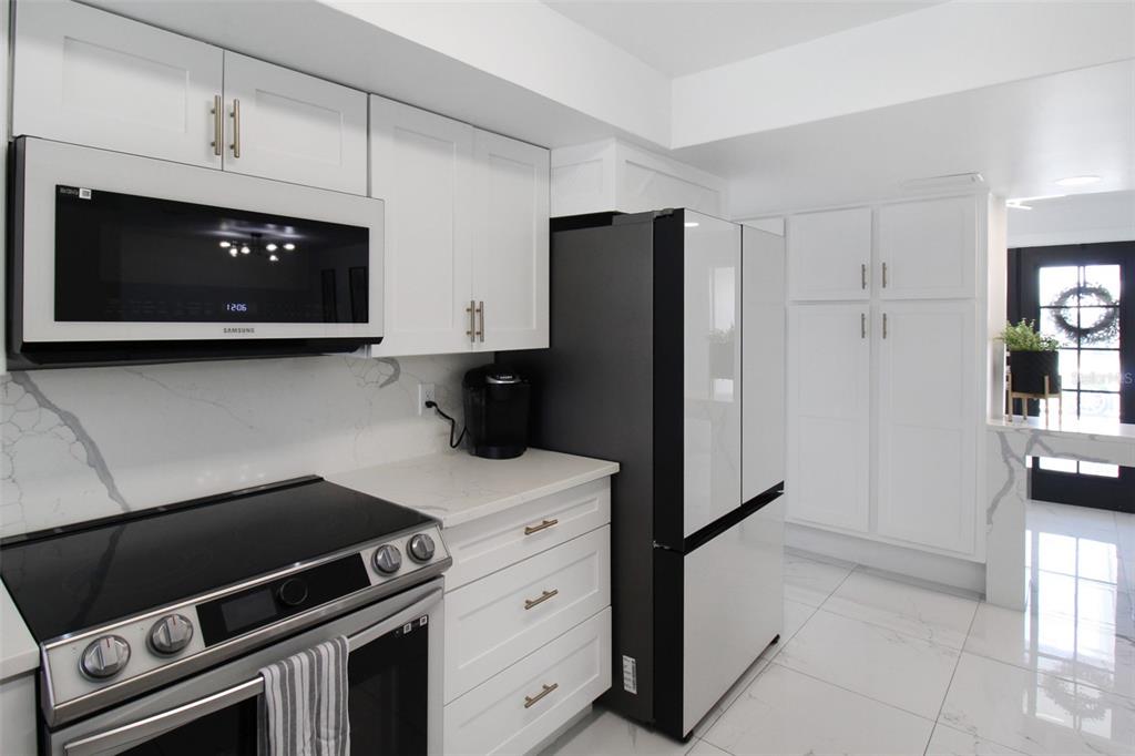 945 Bal Harbor Boulevard Punta Gorda, FL 33950 - Photo 38 of 71 a kitchen with a stove and a microwave