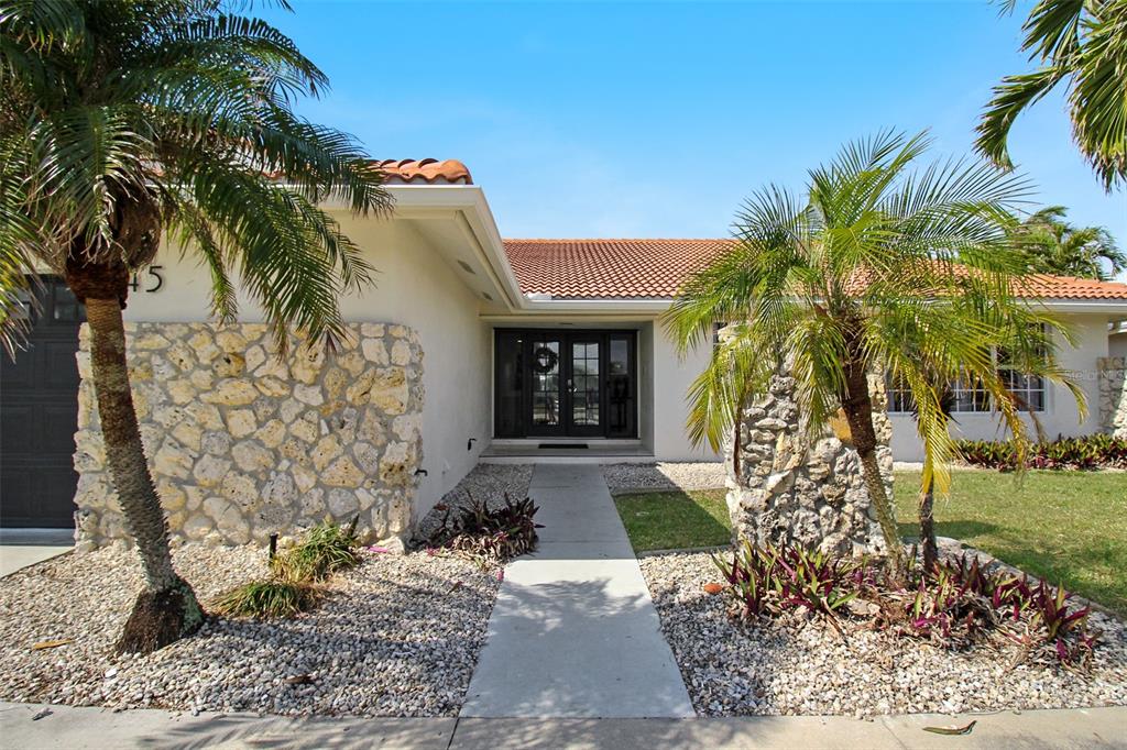 945 Bal Harbor Boulevard Punta Gorda, FL 33950 - Photo 4 of 71 a front view of a house with a yard
