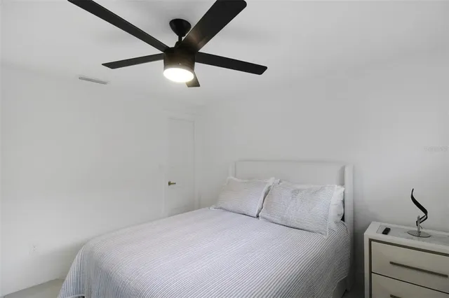 a view of a lake with boats and palm trees