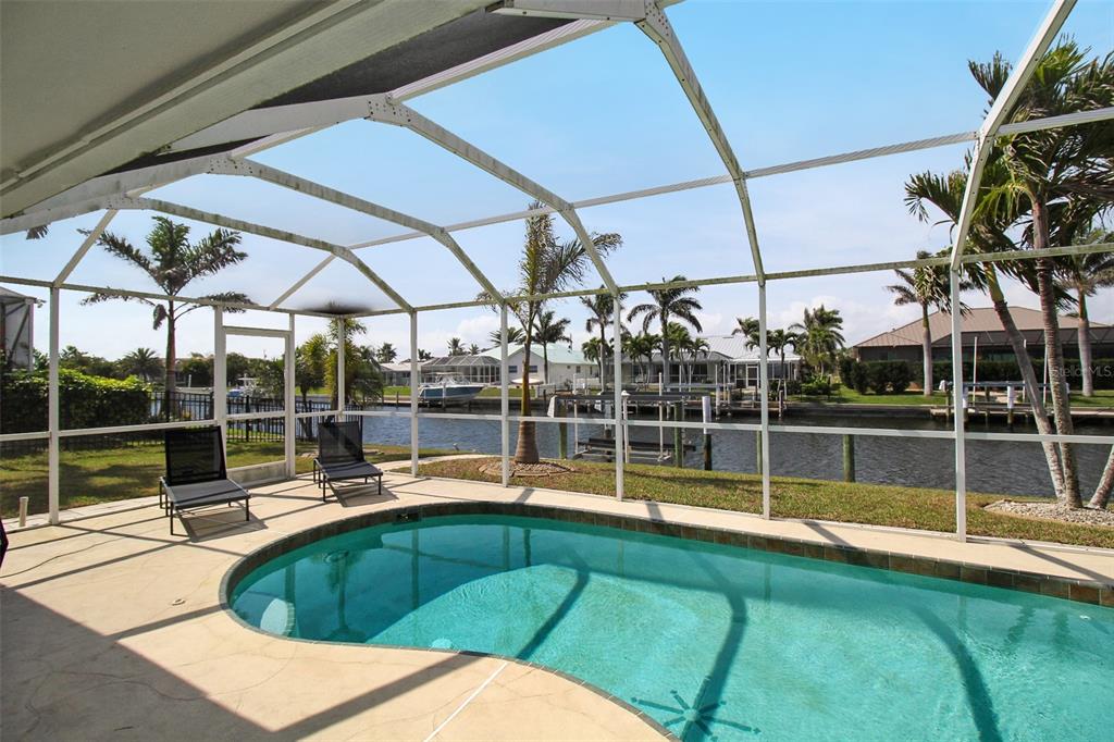 945 Bal Harbor Boulevard Punta Gorda, FL 33950 - Photo 63 of 71 a view of a swimming pool with a bench in front of it