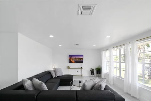 a living room with furniture and a potted plant