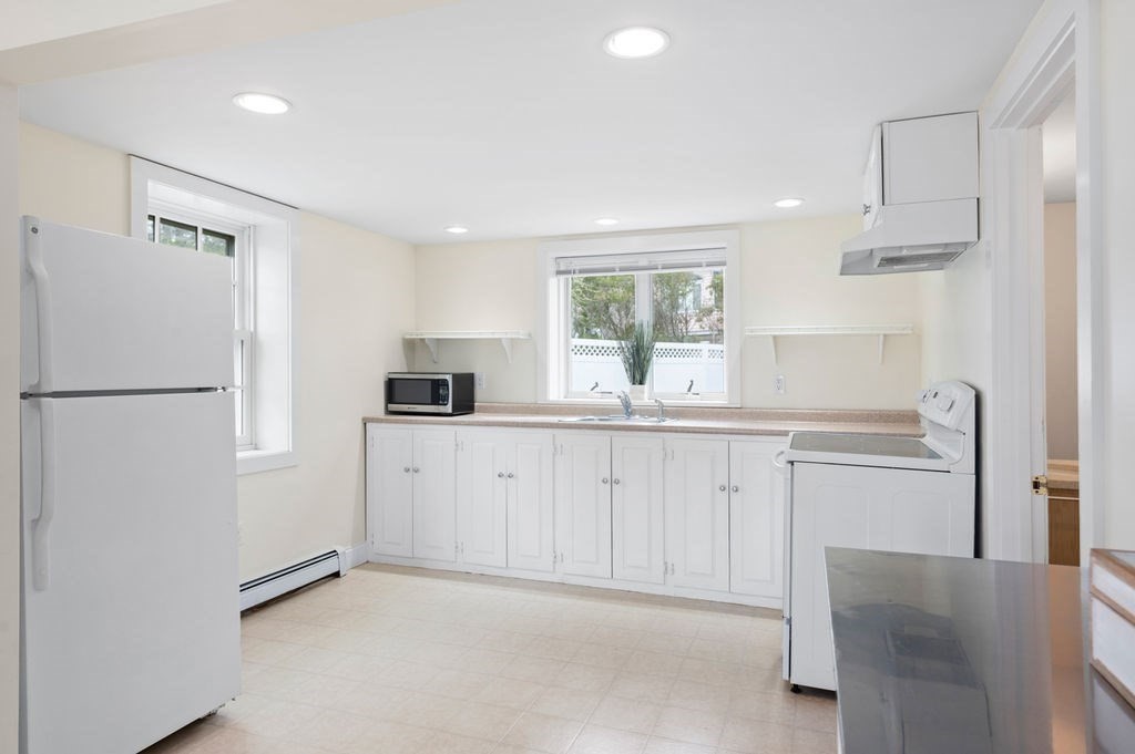 78 Southern Boulevard Newbury, MA 01951 - Photo 9 of 35 a kitchen with white cabinets and refrigerator