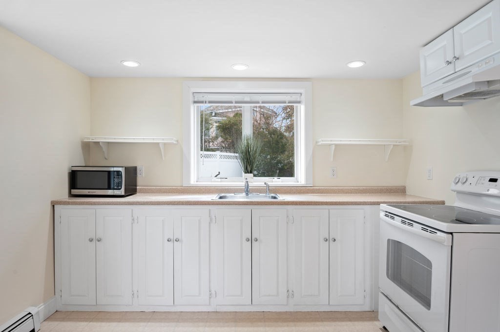 78 Southern Boulevard Newbury, MA 01951 - Photo 10 of 35 a kitchen with granite countertop white cabinets and a sink