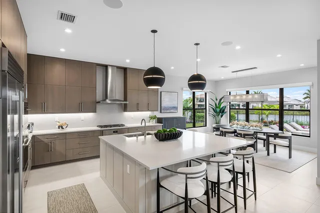 a view of a patio with couches table and chairs under an umbrella