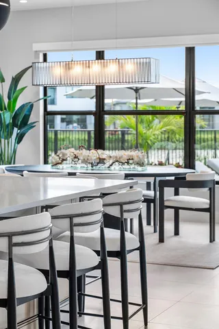 a view of swimming pool with outdoor seating and lake view