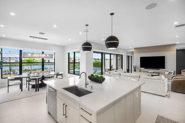 a living room with furniture and a floor to ceiling window