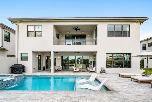 an aerial view of a house with a swimming pool yard and outdoor seating