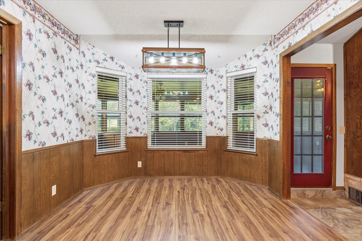 250 Hickory Drive Elgin, TX 78621 - Photo 13 of 37 a view of an empty room with a window and wooden floor