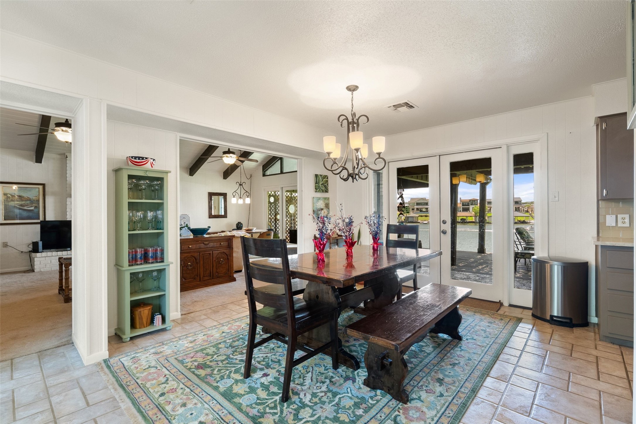 141 Perry Lane Kingsland, TX 78639 - Photo 17 of 40 A refined dining space connects to an outdoor area with tranquil water views.