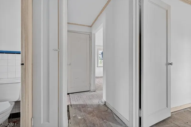 a view of a bathroom from a hallway