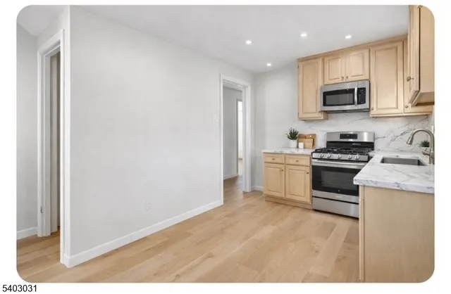 a kitchen with granite countertop white cabinets and white appliances