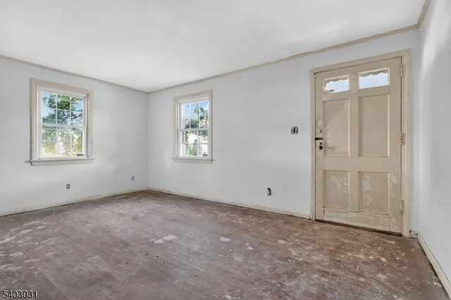 an empty room with windows and closet