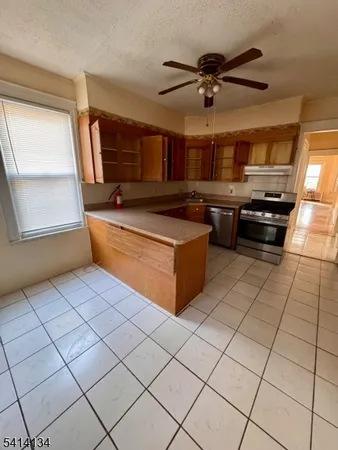 a living room with stainless steel appliances furniture and a large window