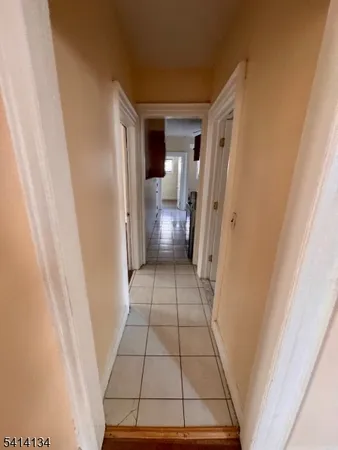 a view of a hallway view with wooden floor and staircase