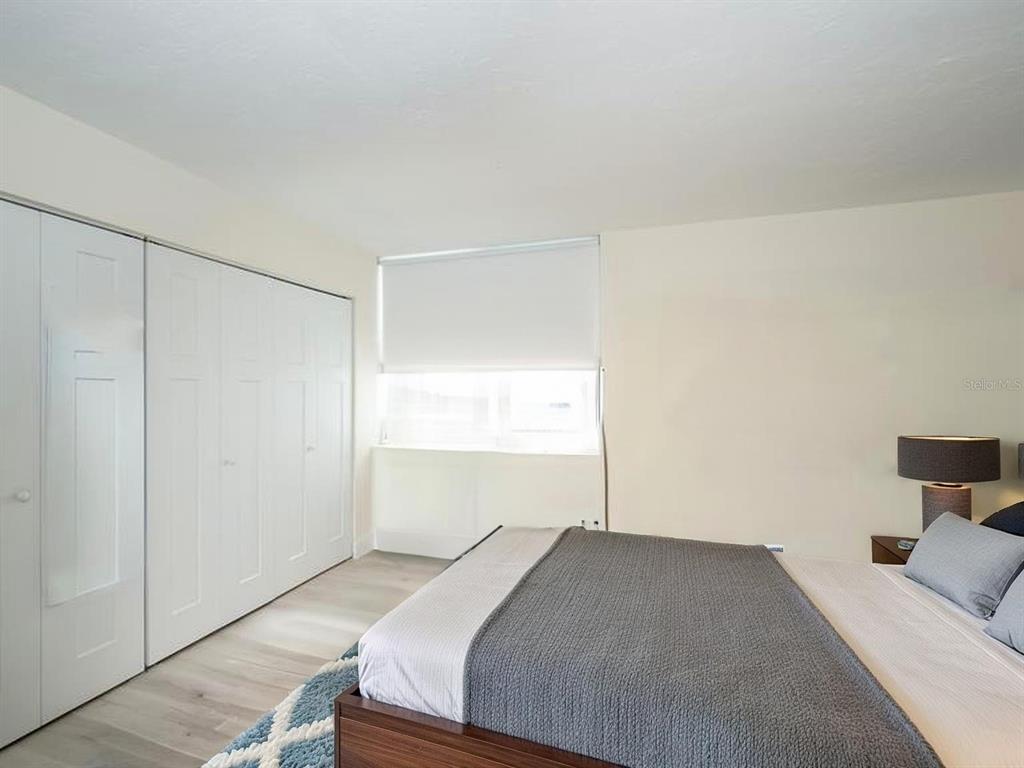 101 South Gulfstream Avenue, Unit 10E Sarasota, FL 34236 - Photo 12 of 54 a bedroom with a bed and a window