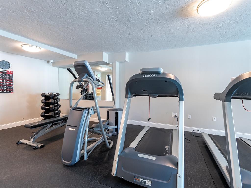 101 South Gulfstream Avenue, Unit 10E Sarasota, FL 34236 - Photo 32 of 54 a room with gym equipment and white walls