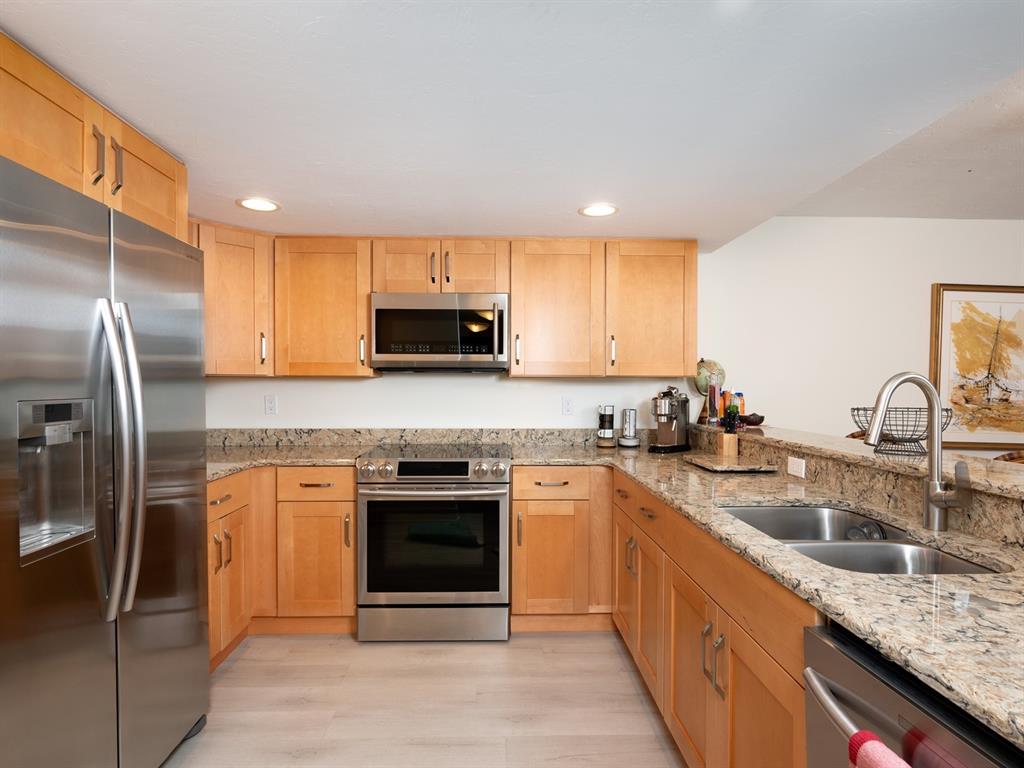 101 South Gulfstream Avenue, Unit 10E Sarasota, FL 34236 - Photo 6 of 54 a kitchen with stainless steel appliances granite countertop a sink stove and refrigerator