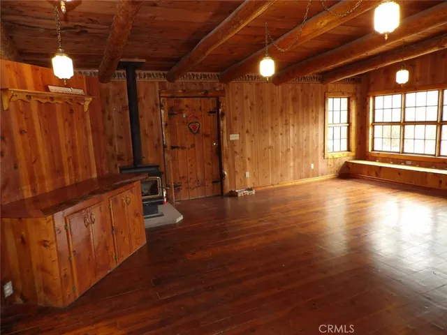 a view of backyard with wooden deck and seating space