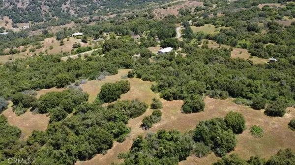 an aerial view of a houses with yard