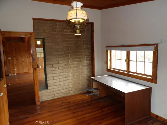 an empty room with wooden floor