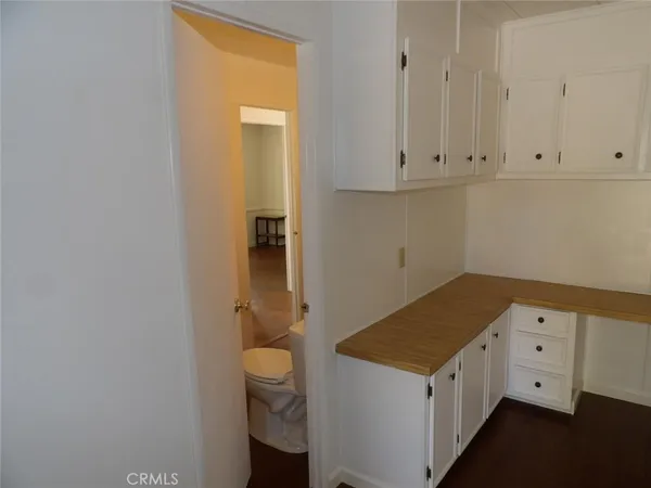 a kitchen with a refrigerator a sink and wooden floor
