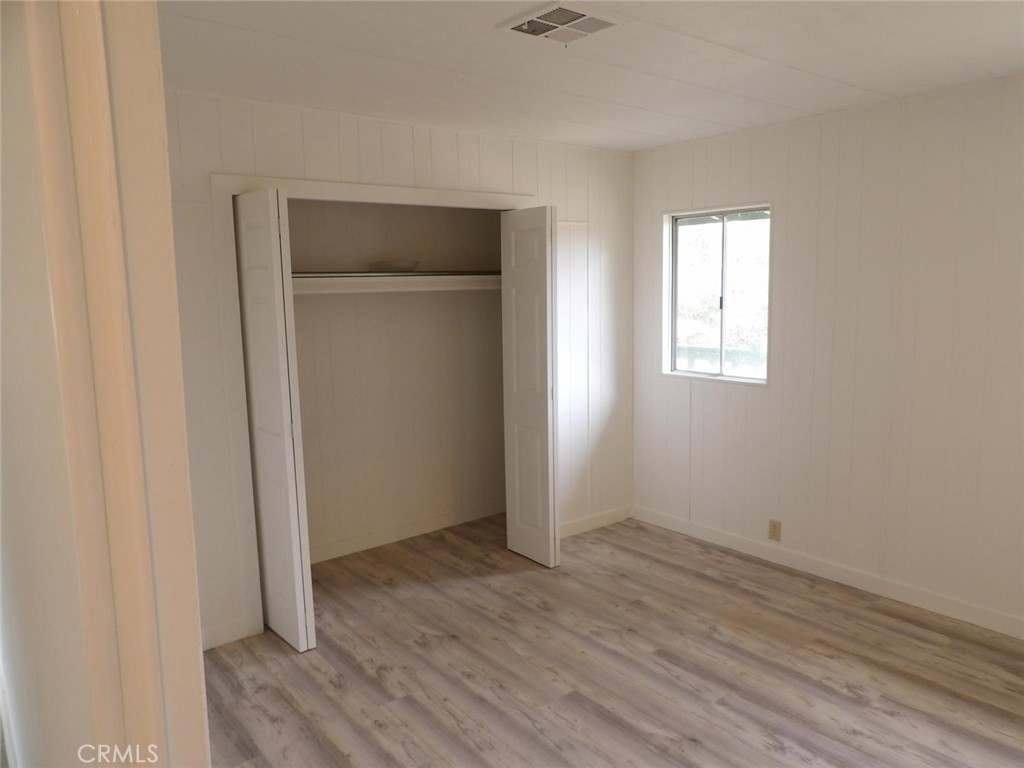 44001 Dunlap Road Miramonte, CA 93641 - Photo 73 of 75 an empty room with wooden floor and windows