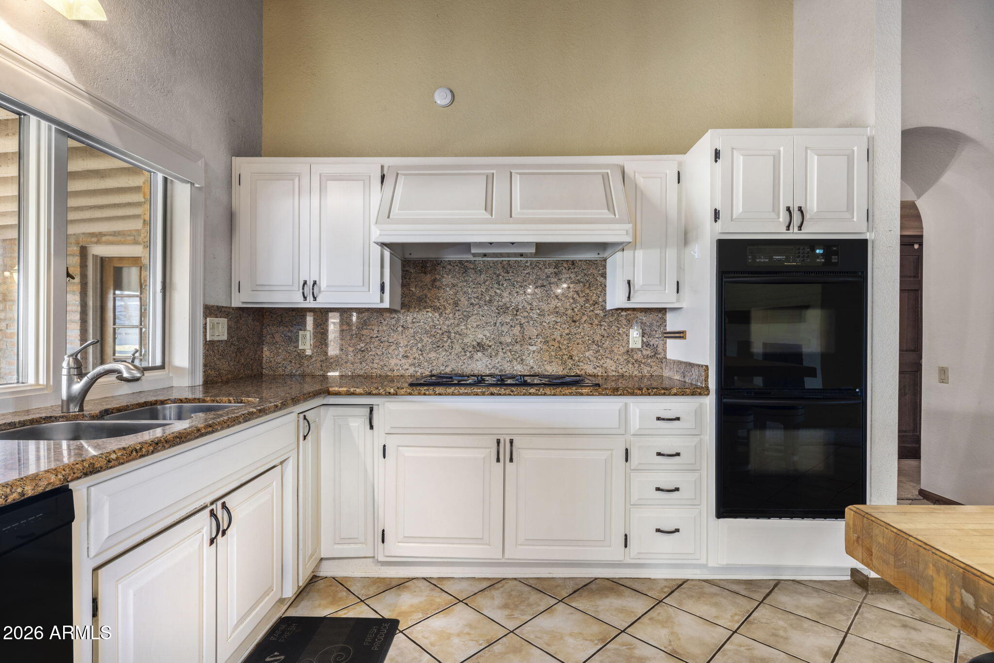 5555 East Turquoise Avenue Paradise Valley, AZ 85253 - Photo 15 of 47 a kitchen with granite countertop white cabinets and refrigerator