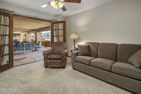 a bathroom with a granite countertop toilet a sink and a mirror