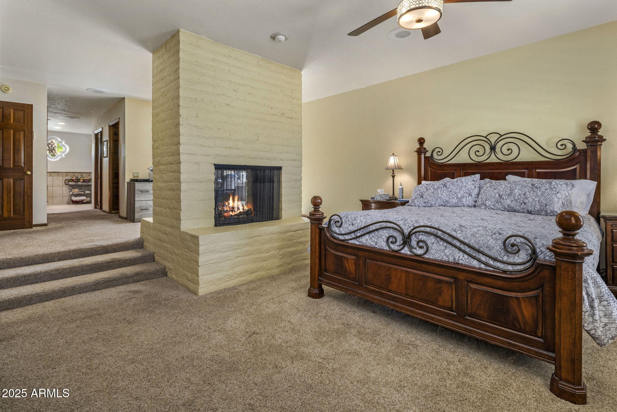 5555 East Turquoise Avenue Paradise Valley, AZ 85253 - Photo 26 of 47 a bedroom with a bed and a fireplace