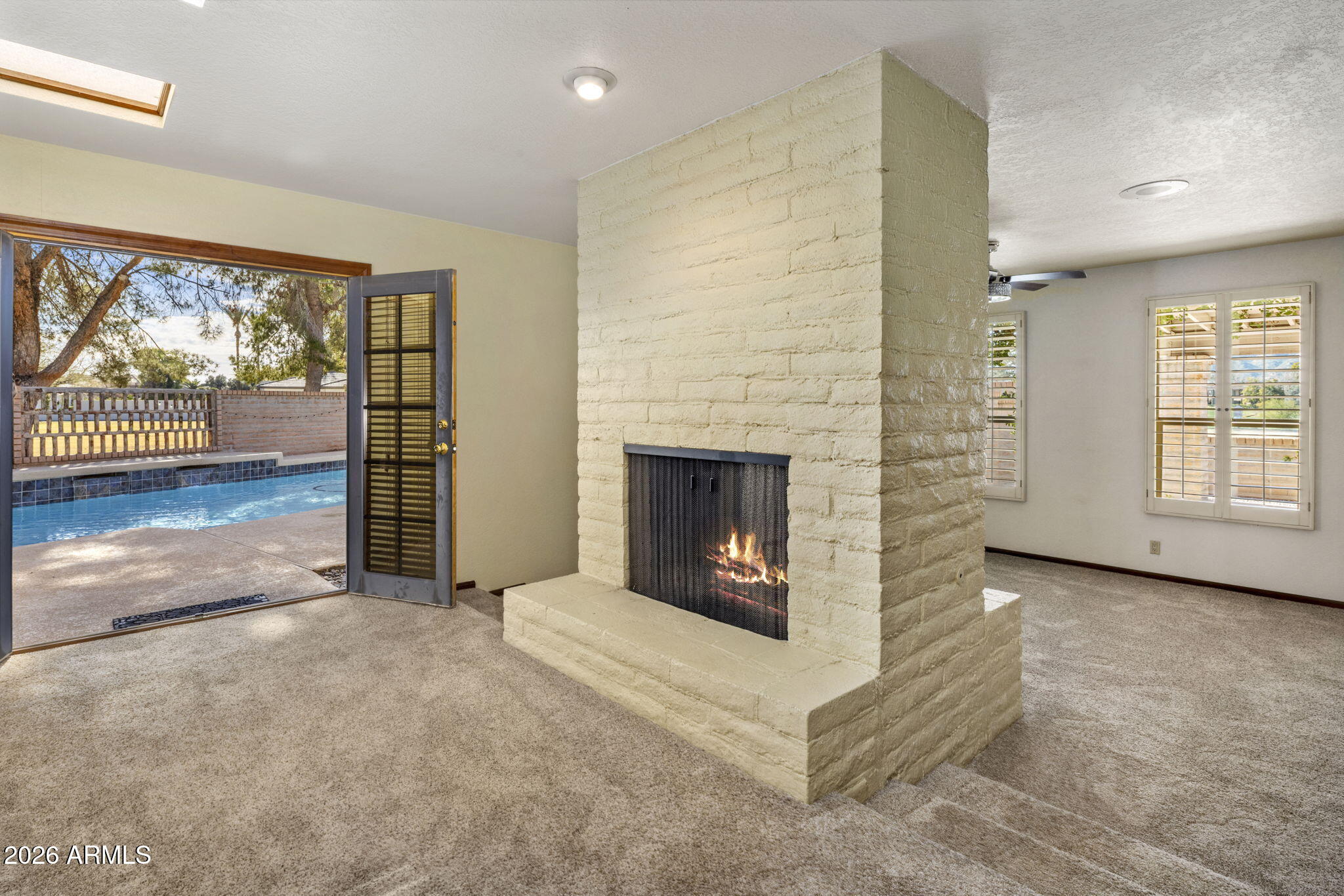 5555 East Turquoise Avenue Paradise Valley, AZ 85253 - Photo 27 of 47 an empty room with windows and fireplace