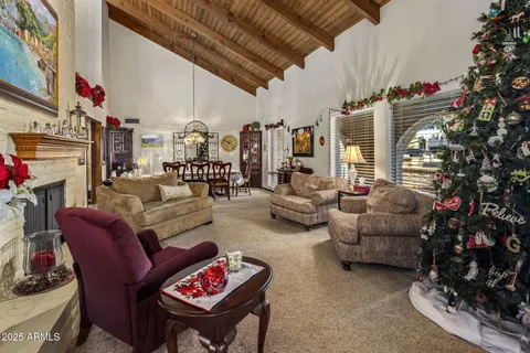 a living room with furniture large window and fireplace