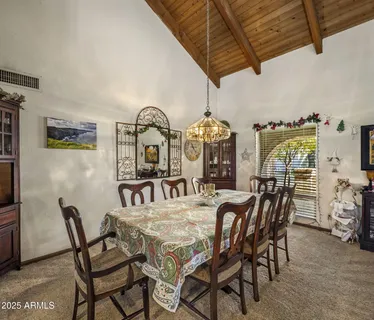 a living room with furniture a fireplace and a chandelier