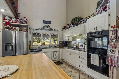 a living room with furniture fireplace and a large window
